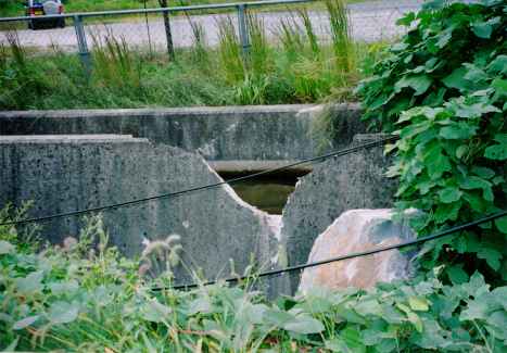 Boulder damaged the ditch concrete wall.